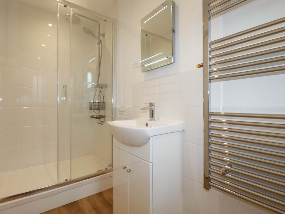 A bathroom with a shower and sink at Folly View in Cambrose near Illogan