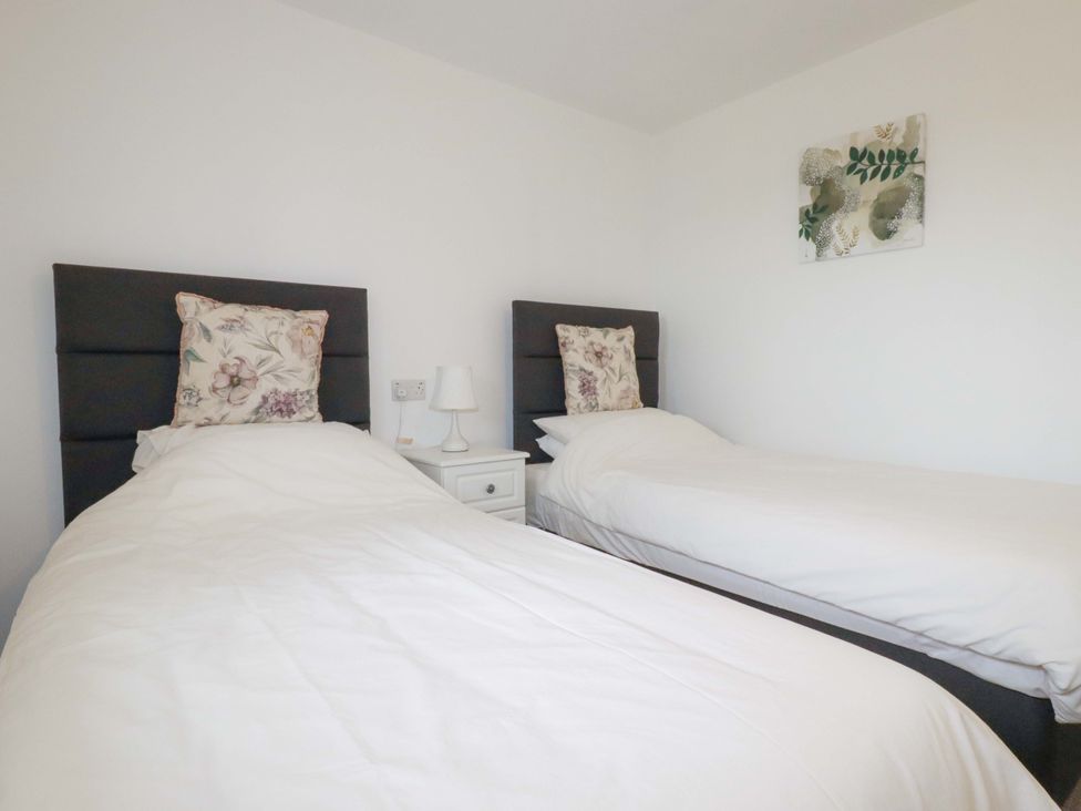 A bedroom with two single beds at Folly View Cambrose near Illogan