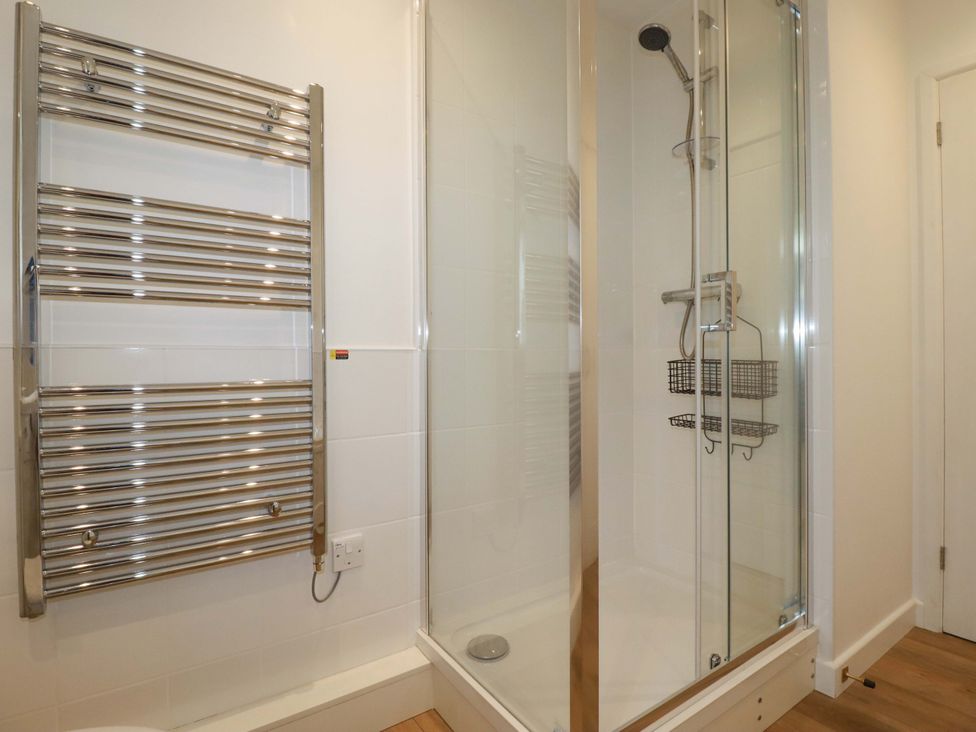 A bathroom with a shower and towel warmer at Folly View in Cambrose near Illogan