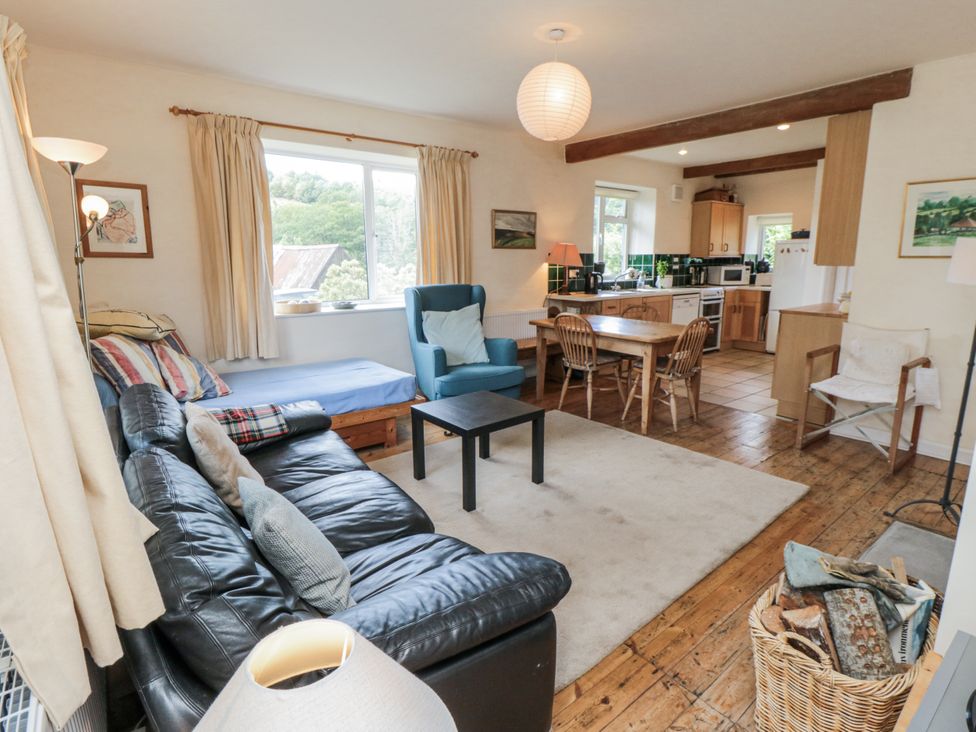 A living room with a sofa and dining table at Low Muffles Bridge 