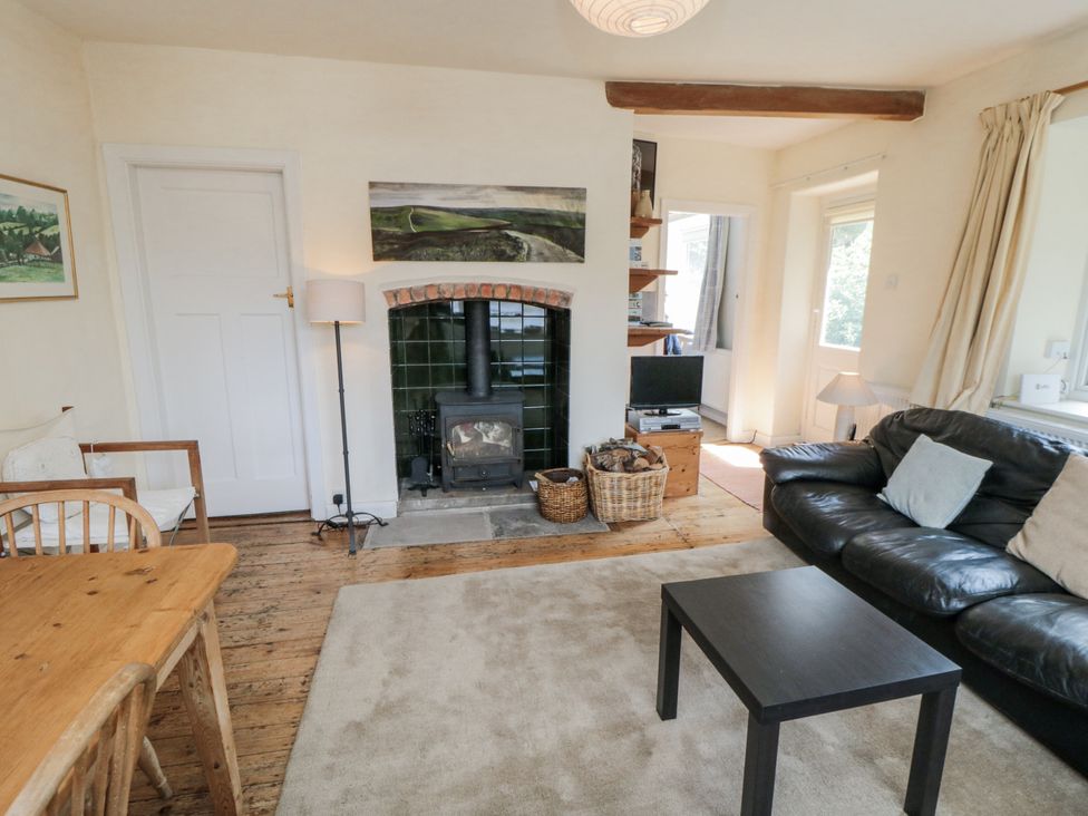 A living room with a fireplace and sofa at Low Muffles Bridge