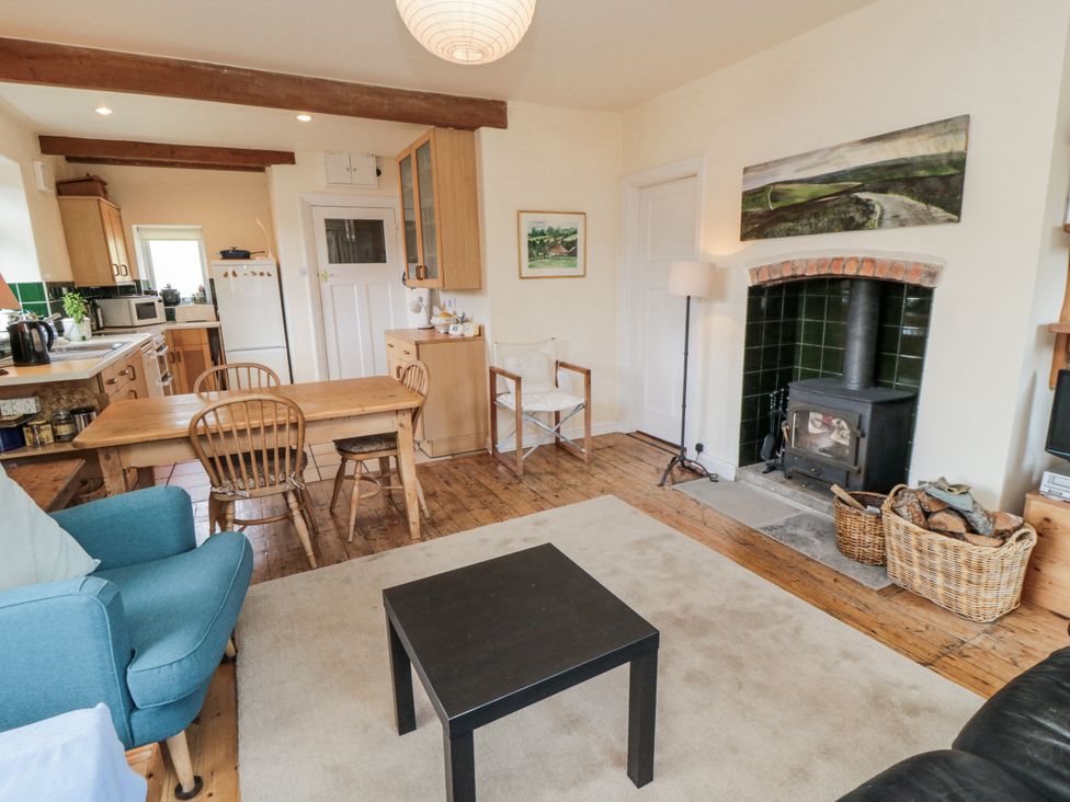 A living room with a table and chairs at Low Muffles Bridge