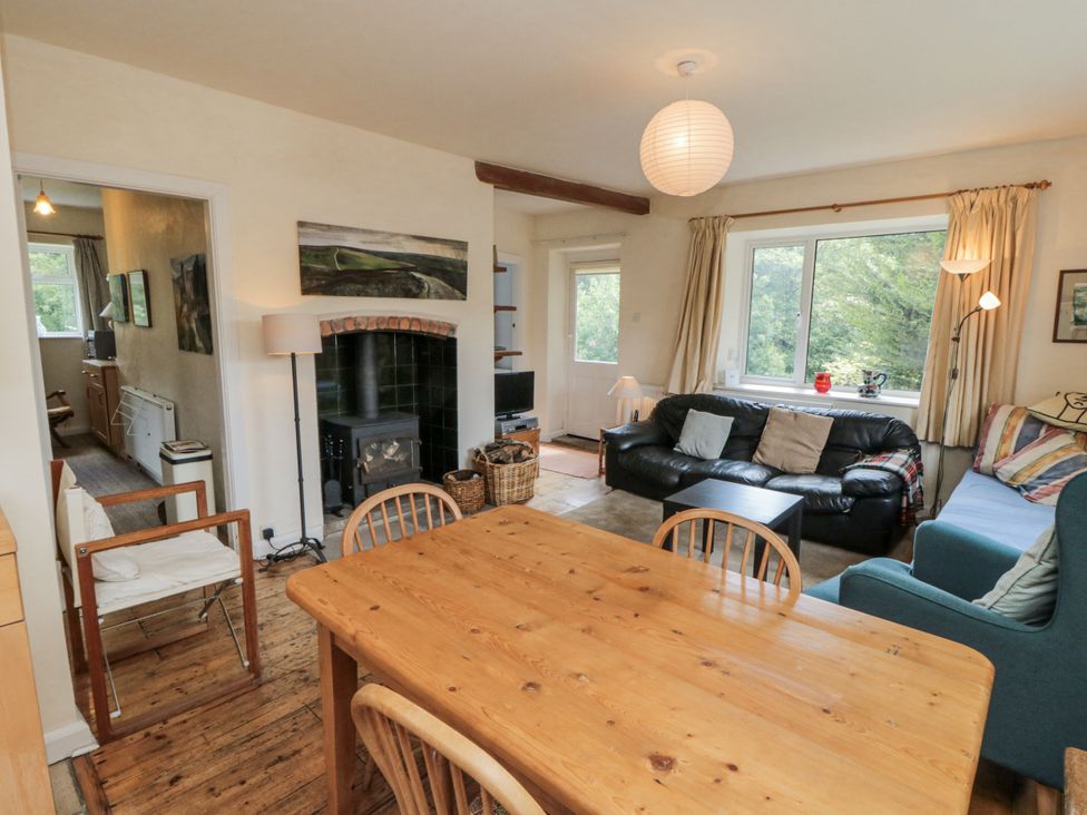 A living room with a dining table and seating area at Low Muffles Bridge