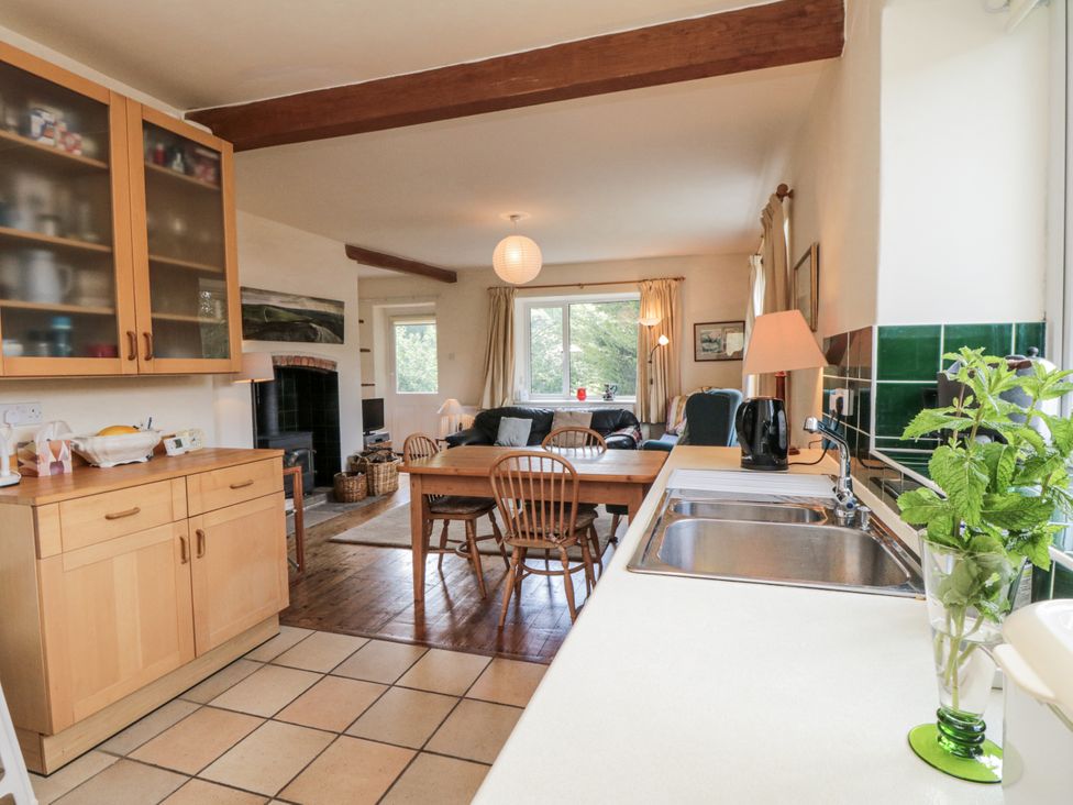 A kitchen with a dining table and chairs at Low Muffles Bridge 