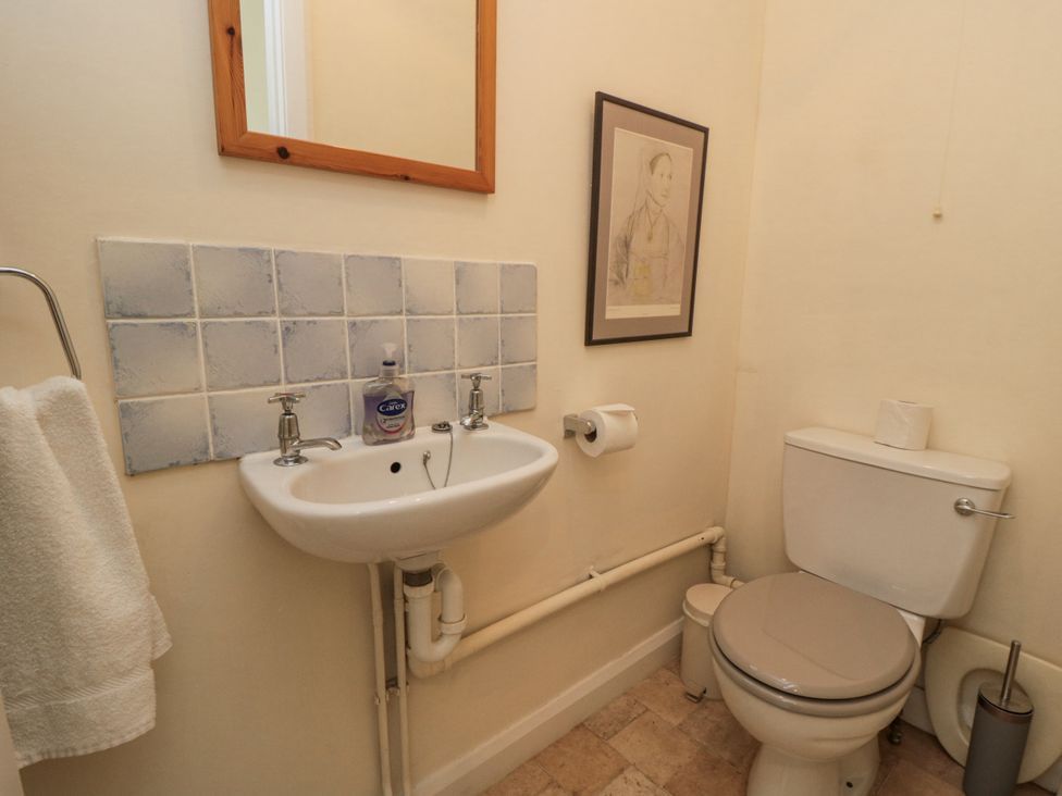 A bathroom with a sink, toilet, and mirror at Low Muffles Bridge