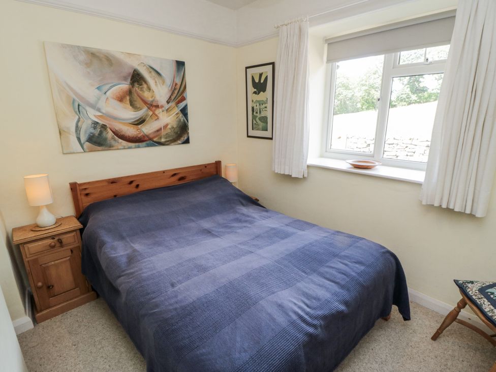 A bedroom with a bed and artwork at Low Muffles Bridge
