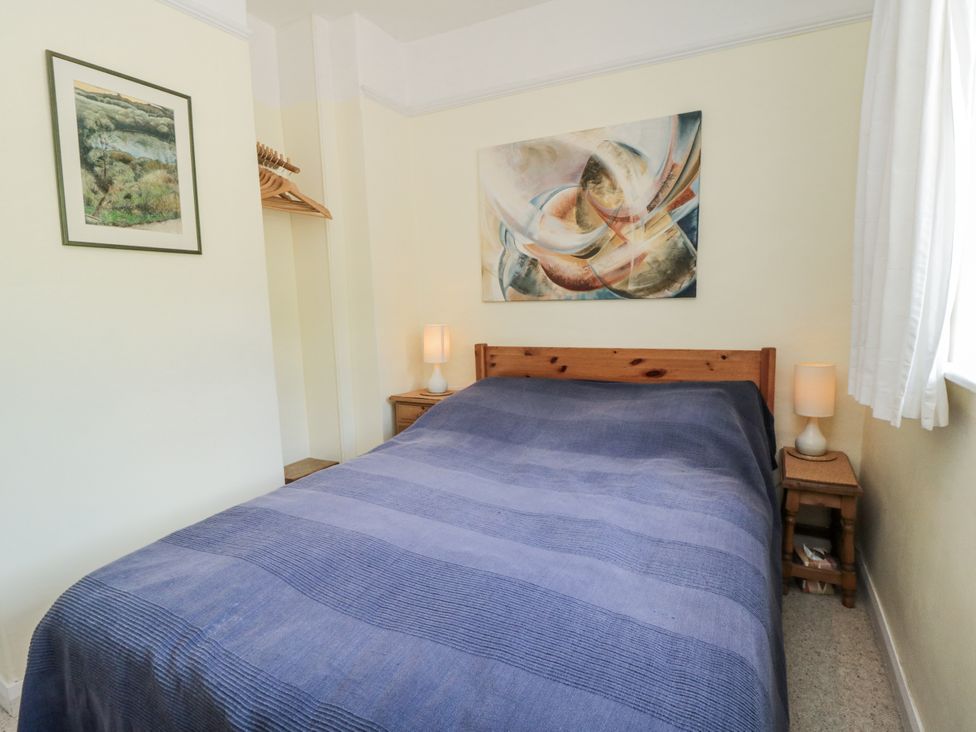A bedroom with a bed and bedside tables at Low Muffles Bridge
