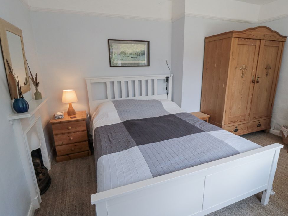 A bedroom with a bed and wardrobe at Low Muffles Bridge 
