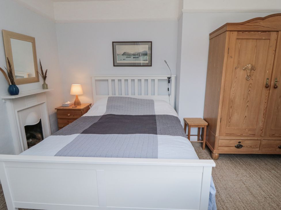 A bedroom with a bed and wardrobe at Low Muffles Bridge