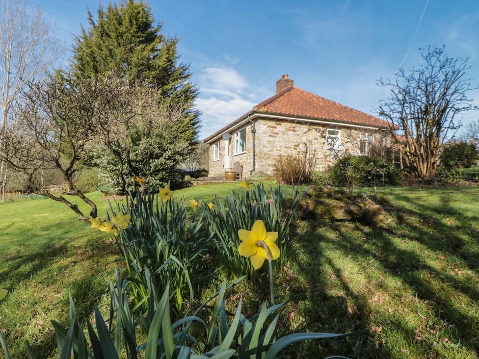 A house with flowers in the garden at Low Muffles Bridge in Hartoft near Rosedale Abbey