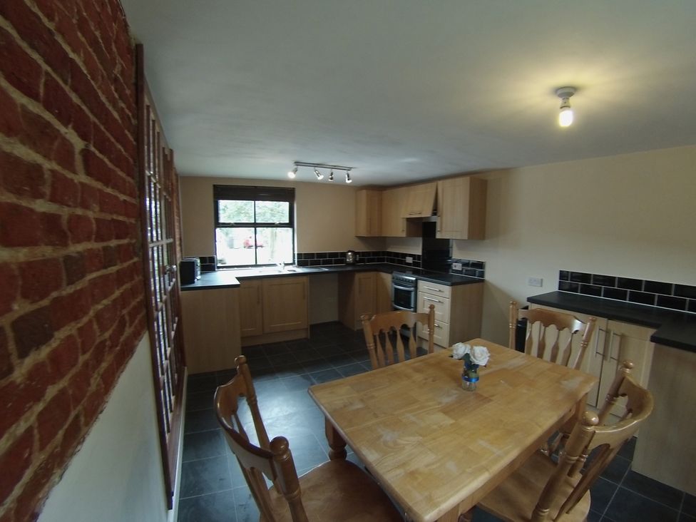 A kitchen with a table and chairs at 1a Old Norwich Road Marsham near Aylsham
