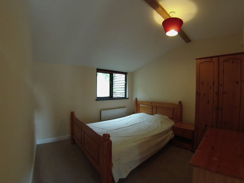 A bedroom with a bed and wardrobe at 1a Old Norwich Road Marsham near Aylsham