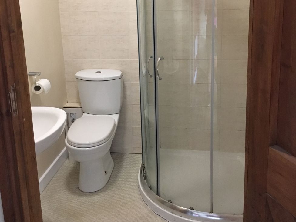 A bathroom with a toilet and a shower at 1a Old Norwich Road Marsham near Aylsham