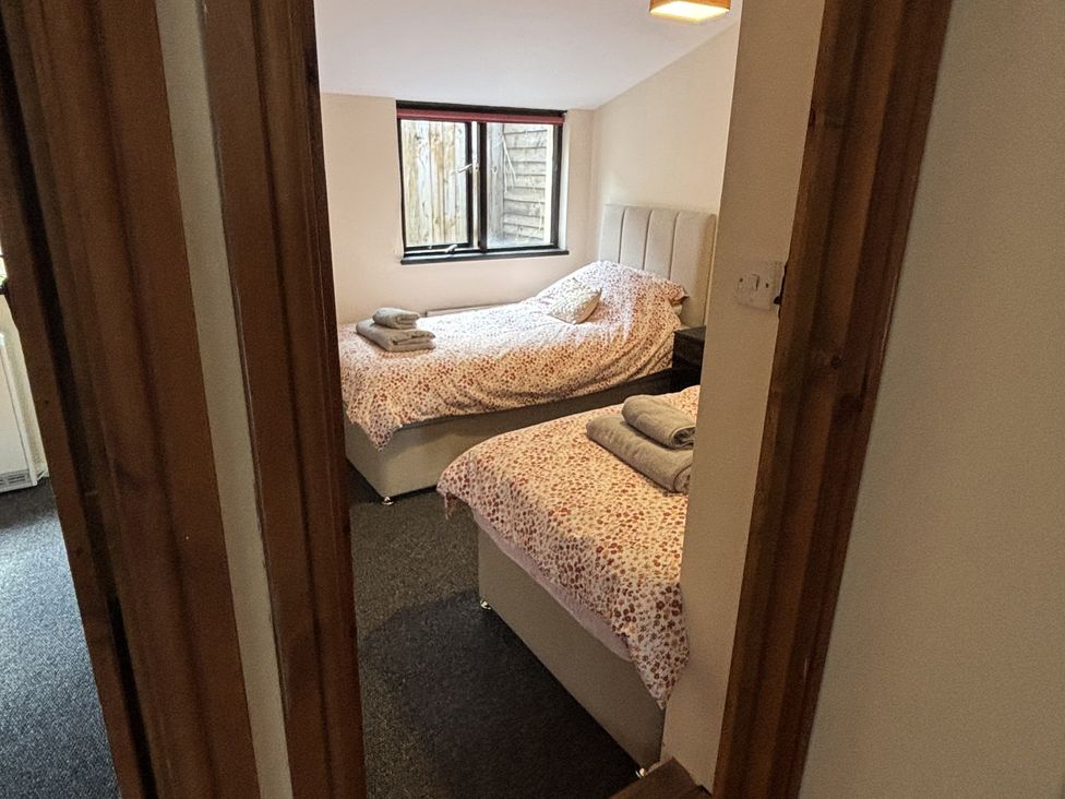 A bedroom with two beds and towels at The Studio in Marsham near Aylsham