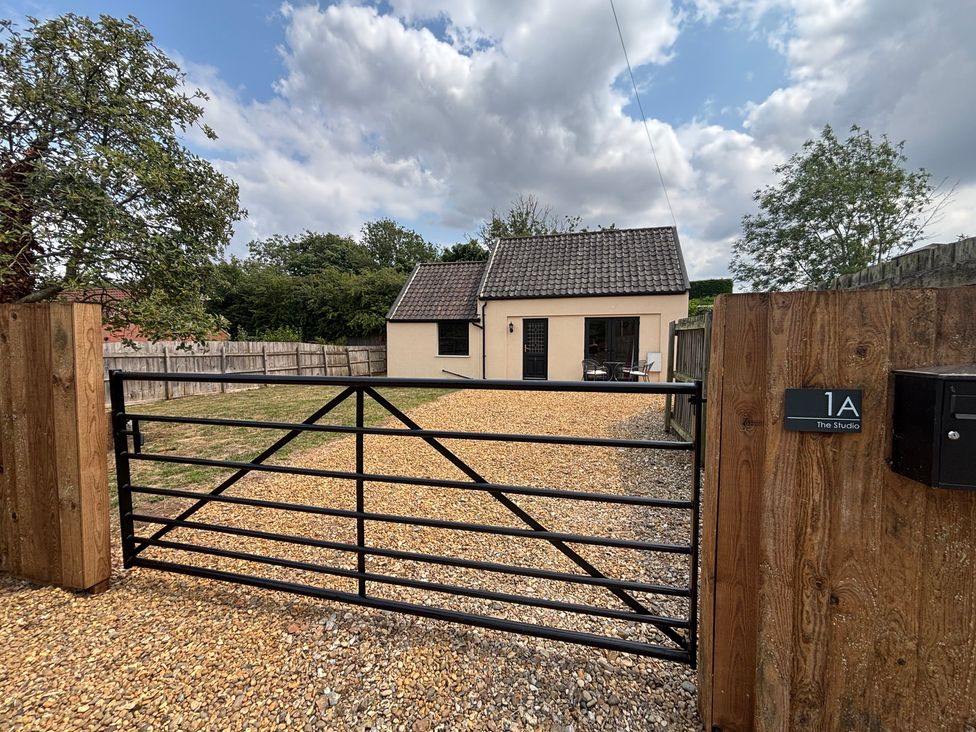 An exterior view of a house with a gravel driveway at The Studio in Marsham near Aylsham