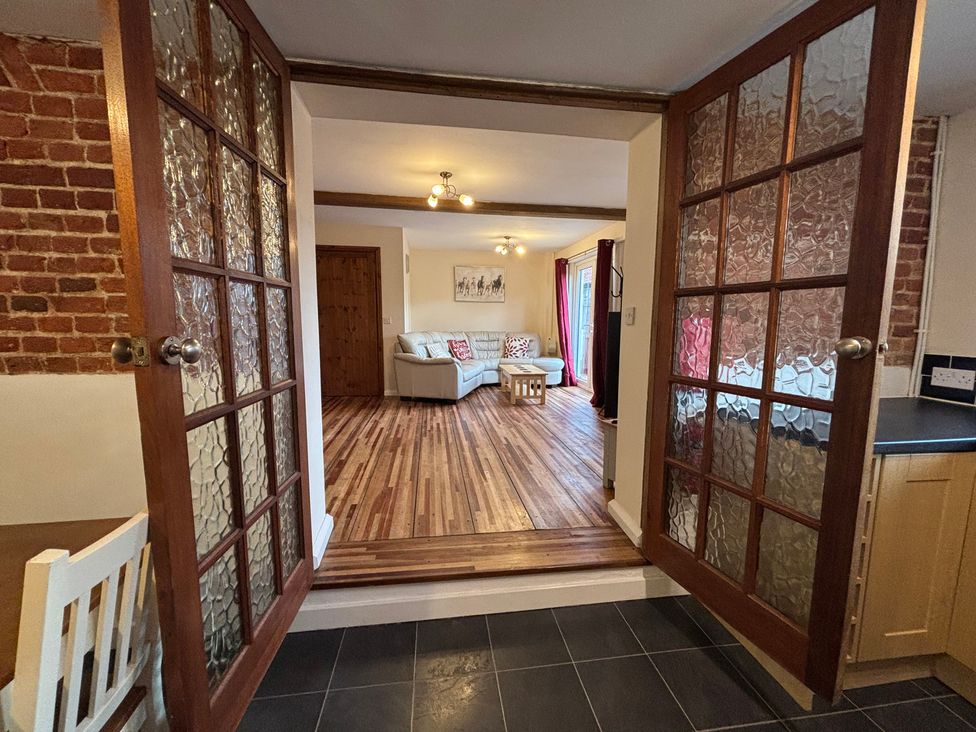 A living room seen through double doors at The Studio in Marsham near Aylsham