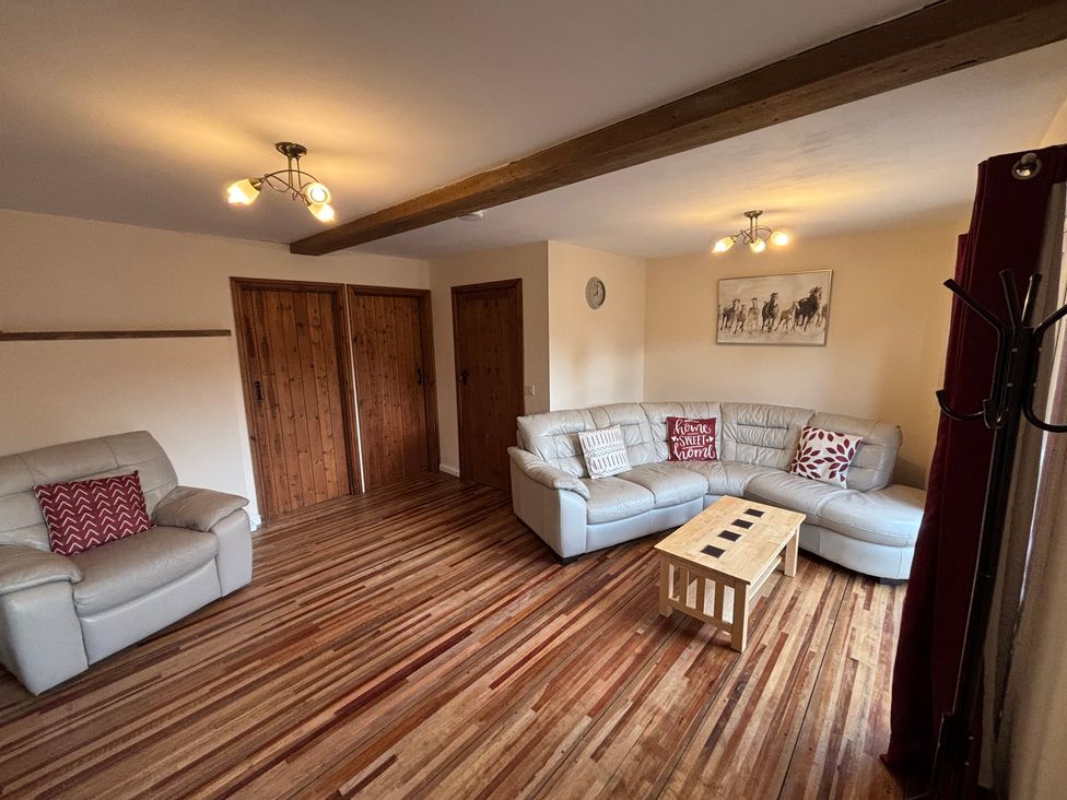 A living room with a sofa and coffee table at The Studio in Marsham near Aylsham