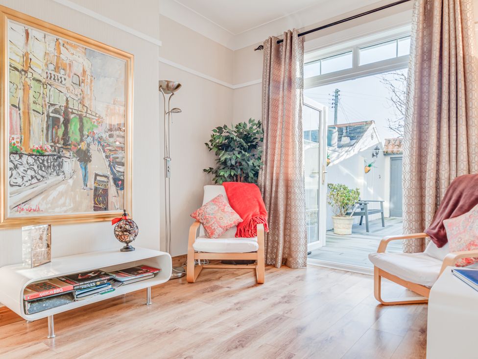 A living room with a painting and armchairs at Tranquility
