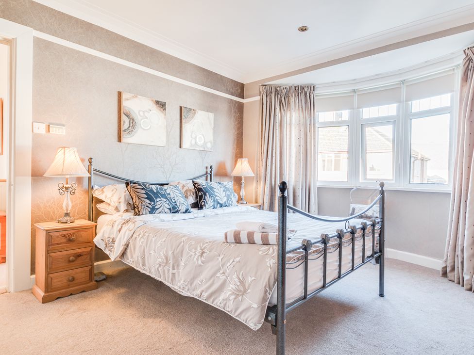 A bedroom with a bed and bedside table at Tranquility