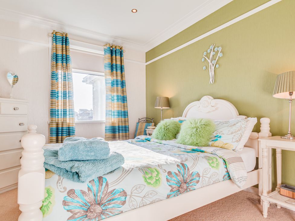 A bedroom with a bed and decorative items at Tranquility in 