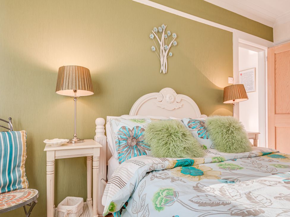 A bedroom with a bed and bedside table at Tranquility