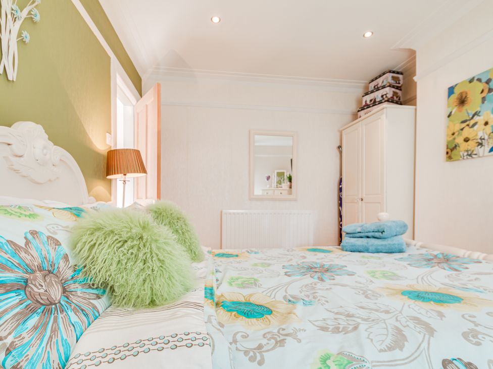 A bedroom with a bed and wardrobe at Tranquility