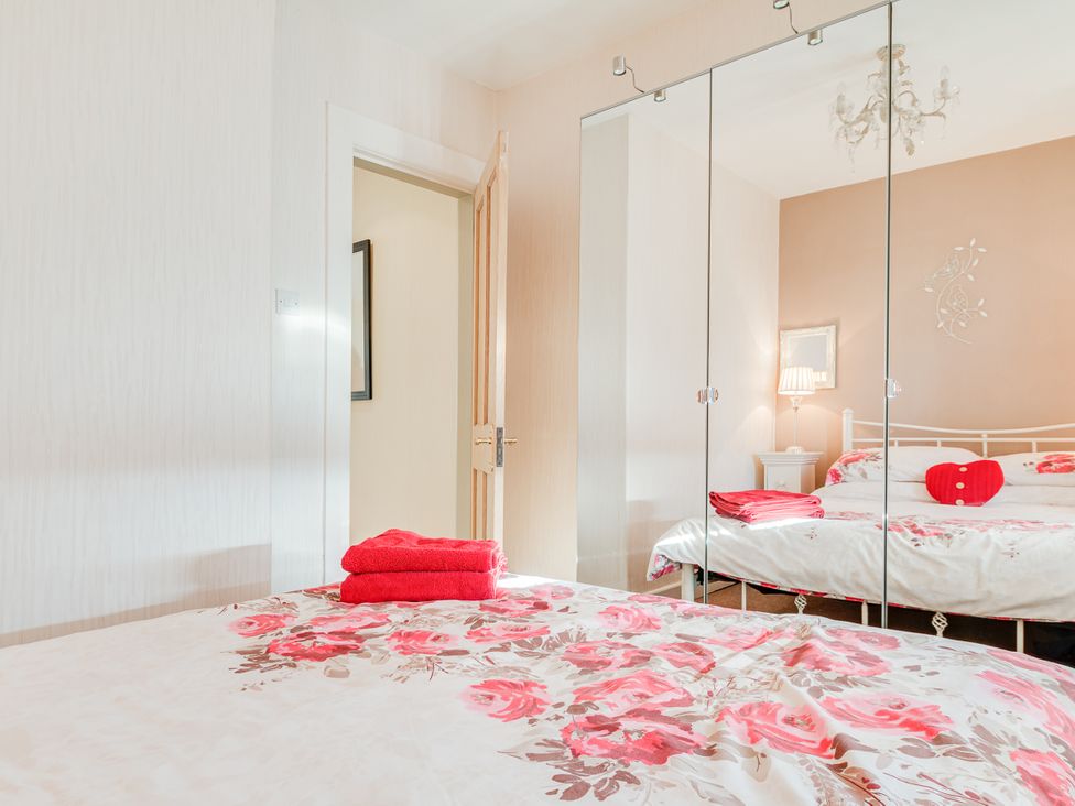 A bedroom with a bed and a mirror at Tranquility