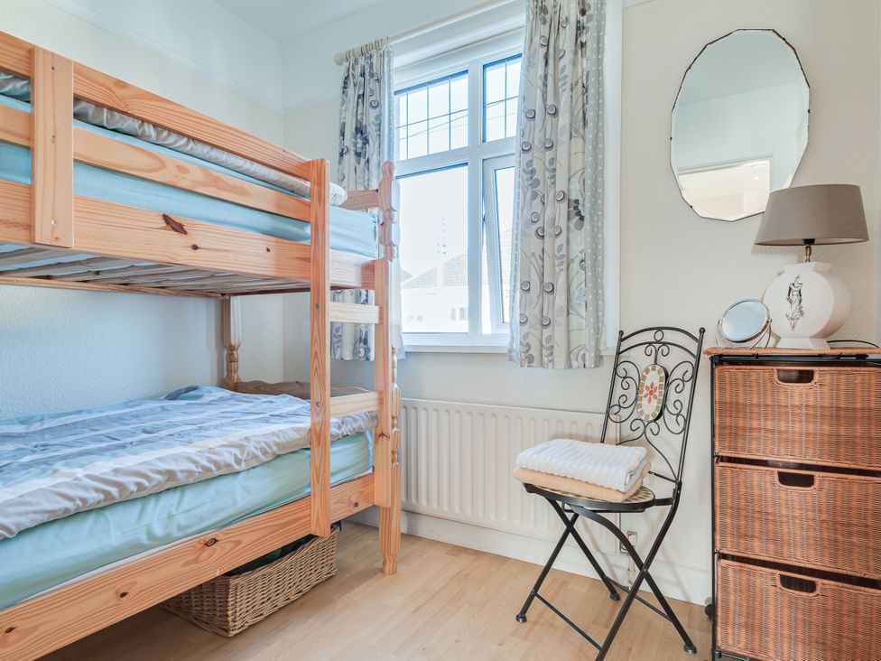 A bedroom with a bunk bed and a chair at Tranquility 