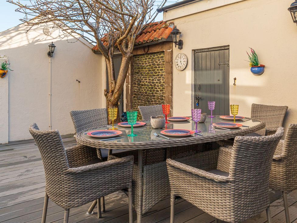 An outdoor dining area with table and chairs at Tranquility