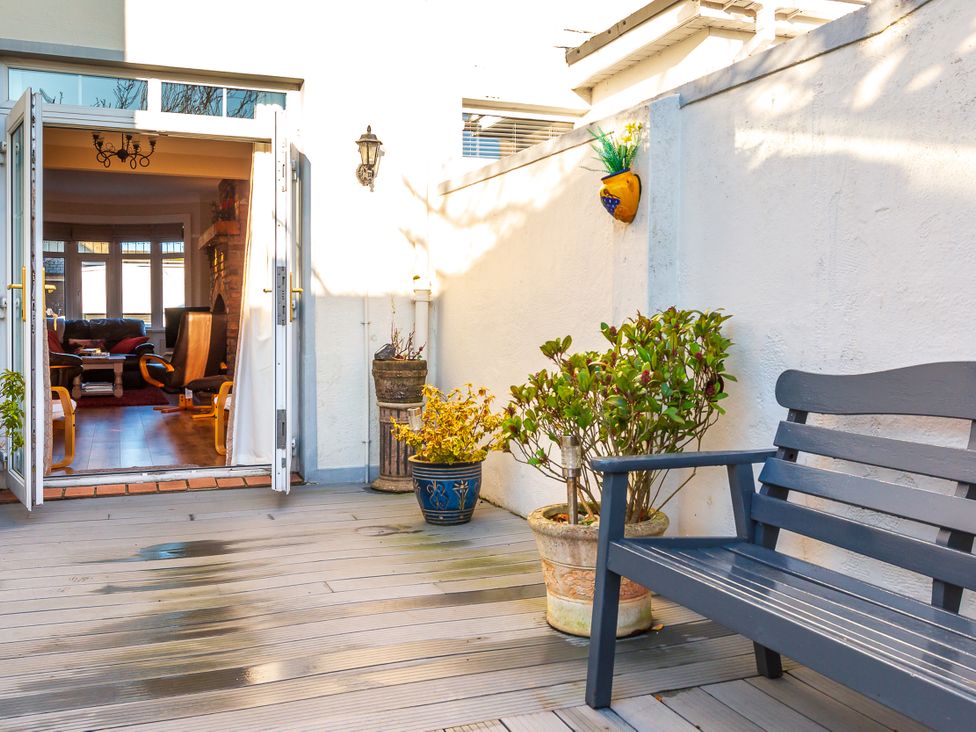 An outdoor area with a bench and flower pots at Tranquility