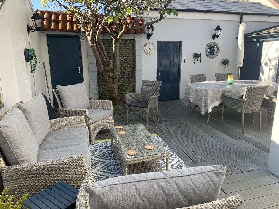 An outdoor seating area with a table and chairs at Tranquility in 