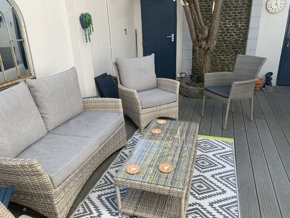 An outdoor seating area with a sofa, armchair, and coffee table at Tranquility
