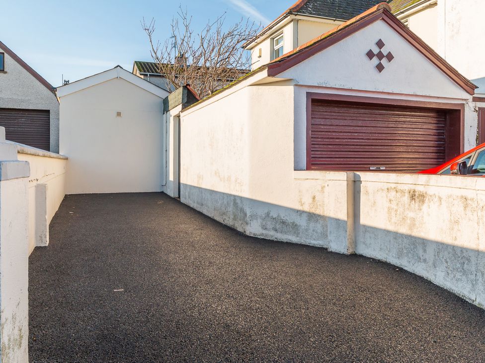 A pathway leading to a garage and a car parked at Tranquility