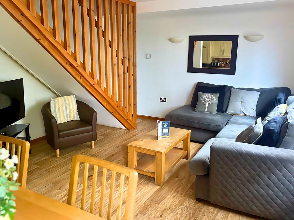 A living room with a sofa and coffee table at Acorn Lodge near Finlakes Holiday Park