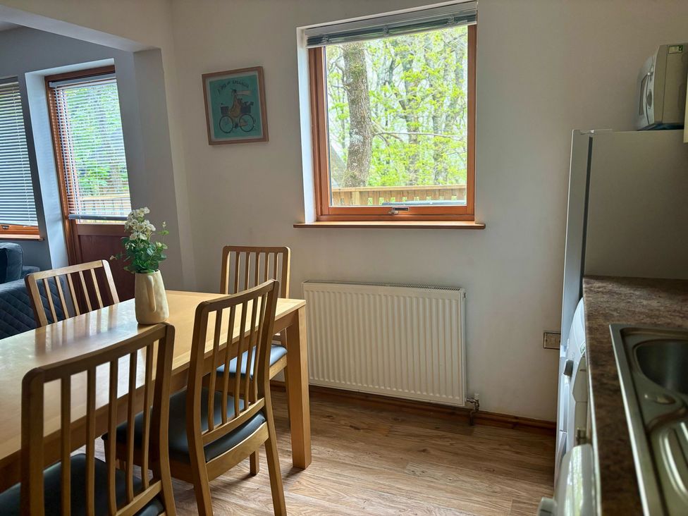 A dining room with a table and chairs at Acorn Lodge Finlakes Holiday Park near Chudleigh