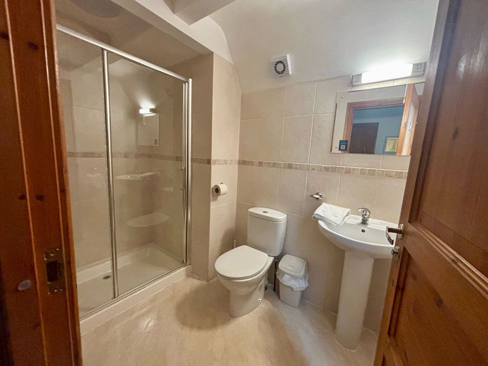 A bathroom with shower, toilet, and sink at Acorn Lodge Finlakes Holiday Park near Chudleigh