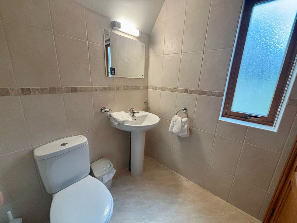A bathroom with a toilet and sink at Acorn Lodge Finlakes Holiday Park near Chudleigh