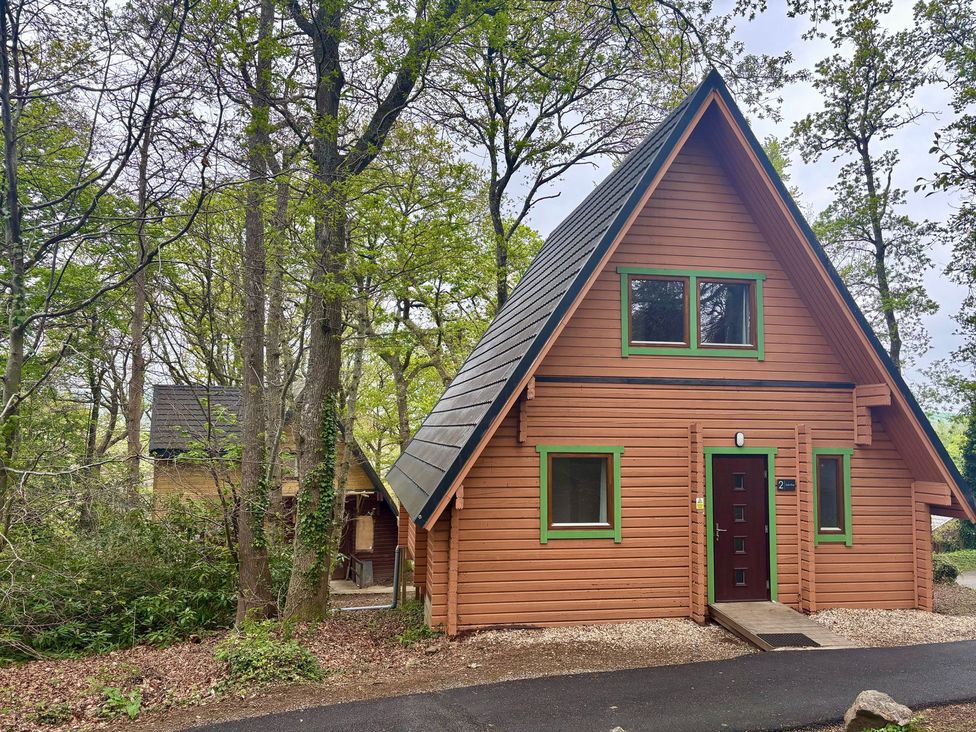 A cabin surrounded by trees at Acorn Lodge Finlakes Holiday Park near Chudleigh