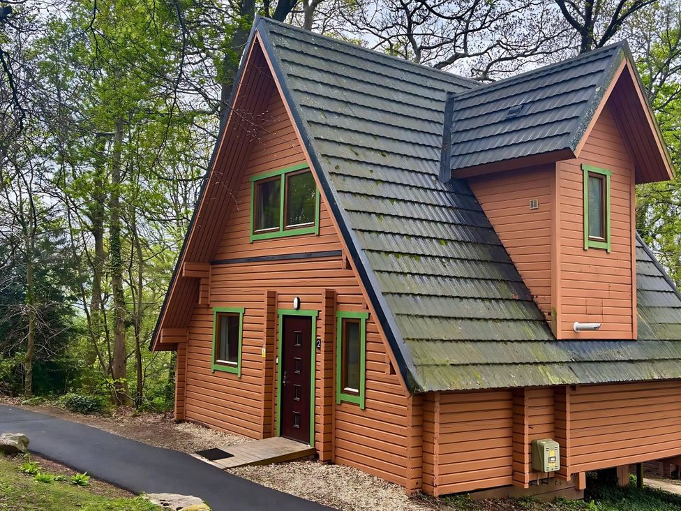 A wooden cabin with a sloped roof at Acorn Lodge Finlakes Holiday Park near Chudleigh