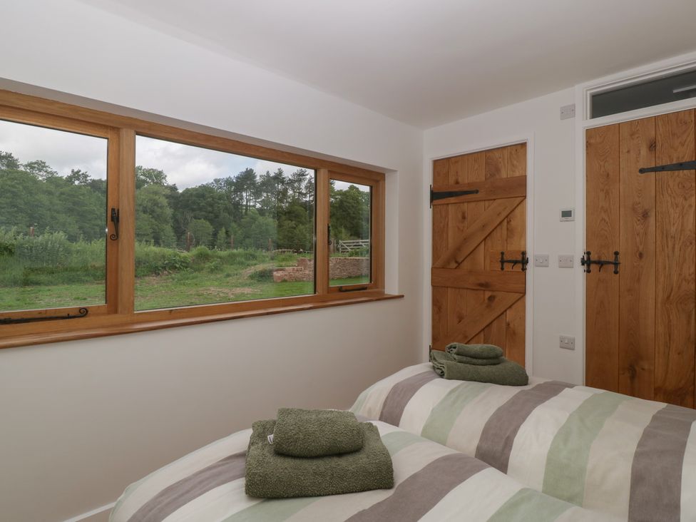 A bedroom with beds and towels at Monnow in Pandy near Longtown (hereford)