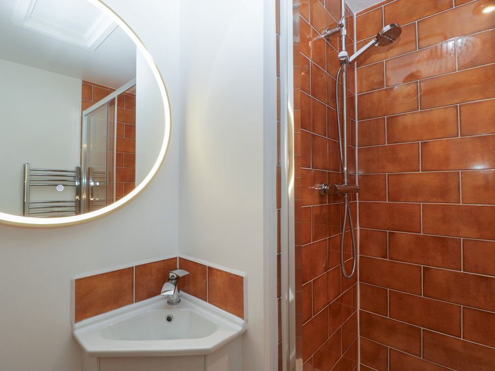 A bathroom with a shower and sink at Monnow in Pandy near Longtown (hereford)
