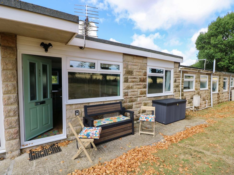 An outdoor seating area with a bench and chairs at No 157 Sandown Bay Holiday Chalet 'Field View' Sandown