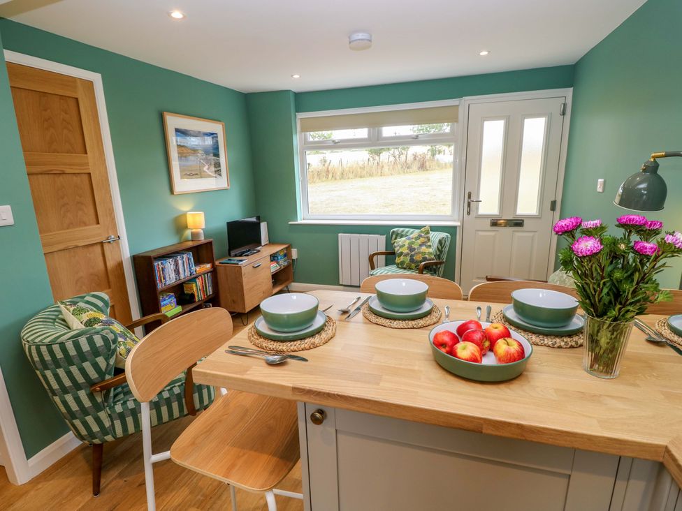 A dining area with a table and chairs at No 157 Sandown Bay Holiday Chalet 'Field View' Sandown