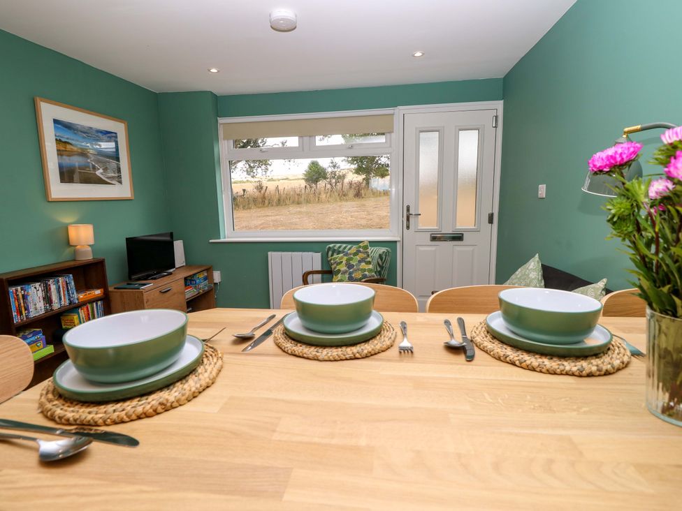 A dining room with a table set for meals at No 157 Sandown Bay Holiday Chalet 'Field View' Sandown