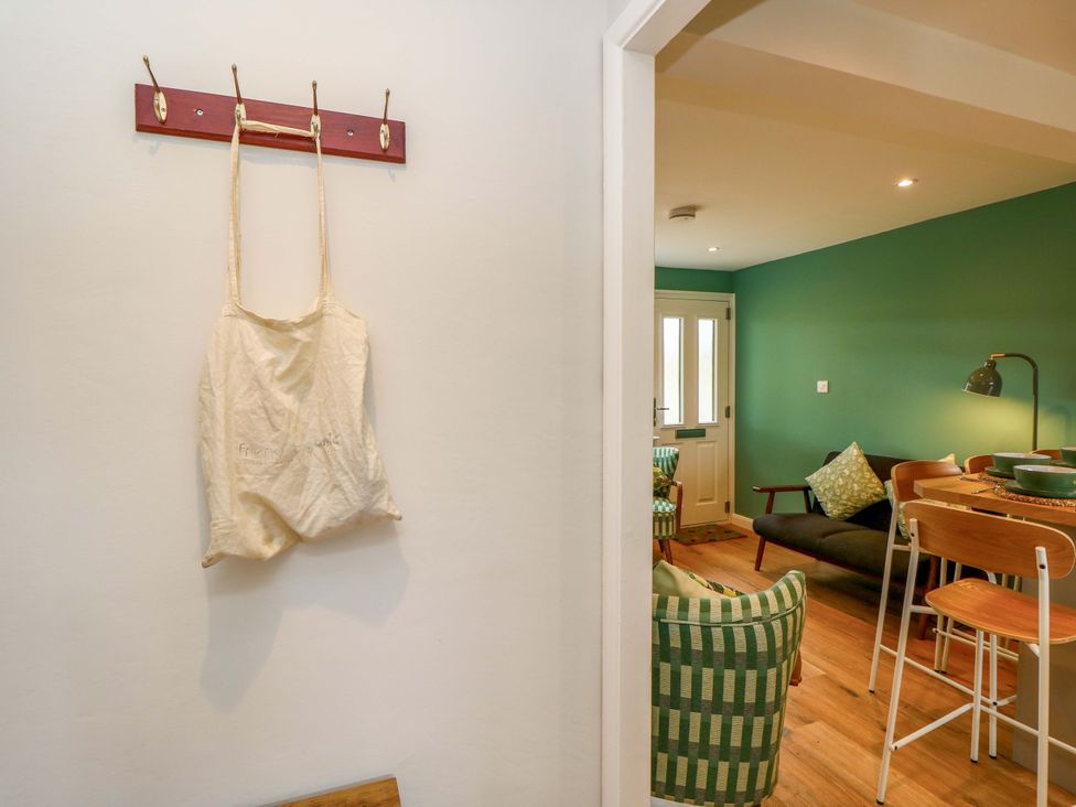 An entryway with a hook rack and canvas bag at No 157 Sandown Bay Holiday Chalet 'Field View' Sandown