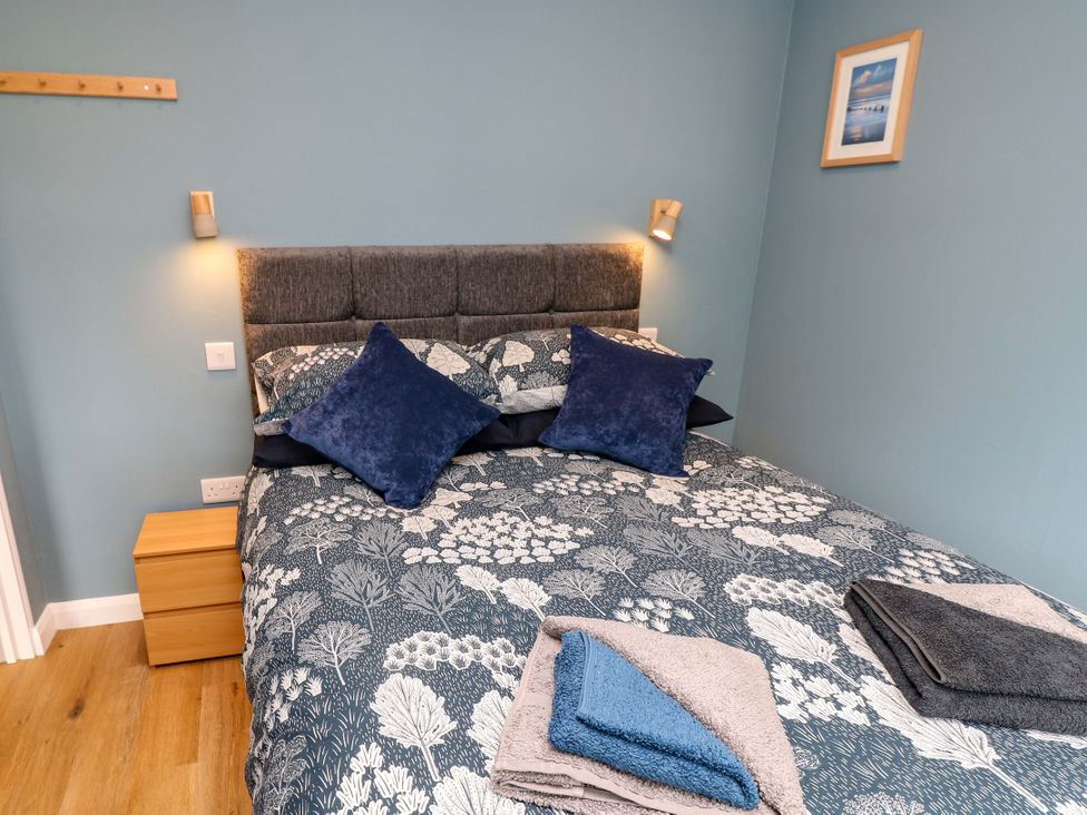 A bedroom with a bed and bedside table at No 157 Sandown Bay Holiday Chalet 'Field View' Sandown