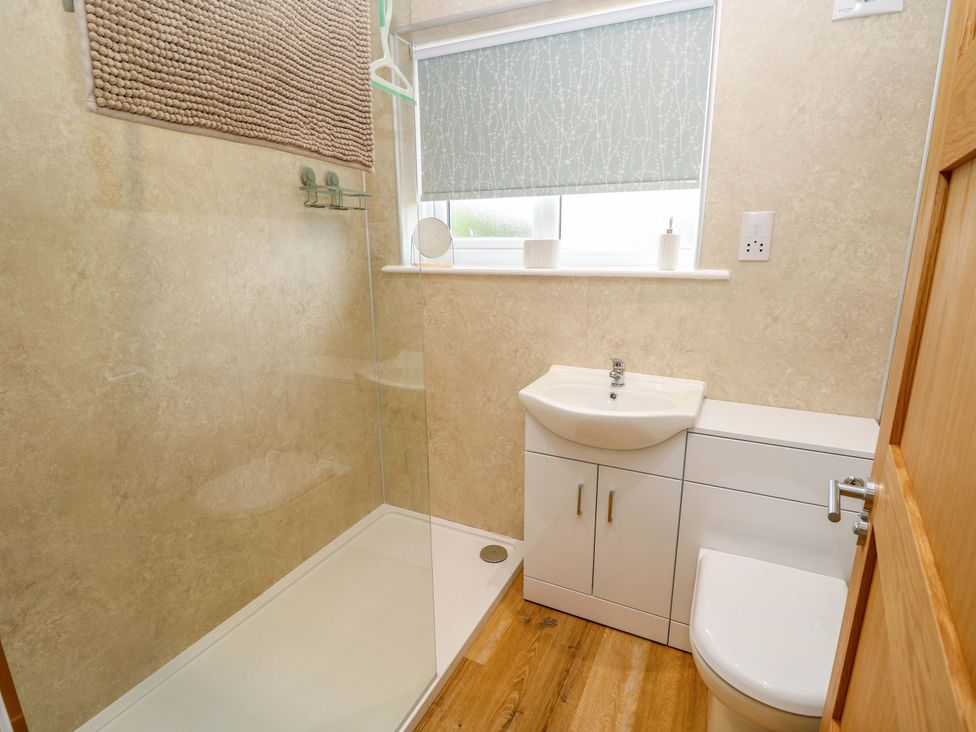 A bathroom with a shower, sink, and toilet at No 157 Sandown Bay Holiday Chalet 'Field View' Sandown