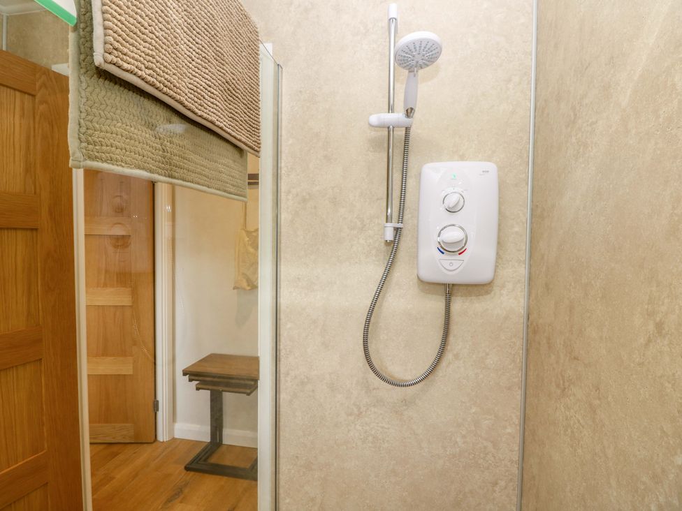 A shower with water control unit and table at No 157 Sandown Bay Holiday Chalet 'Field View' Sandown