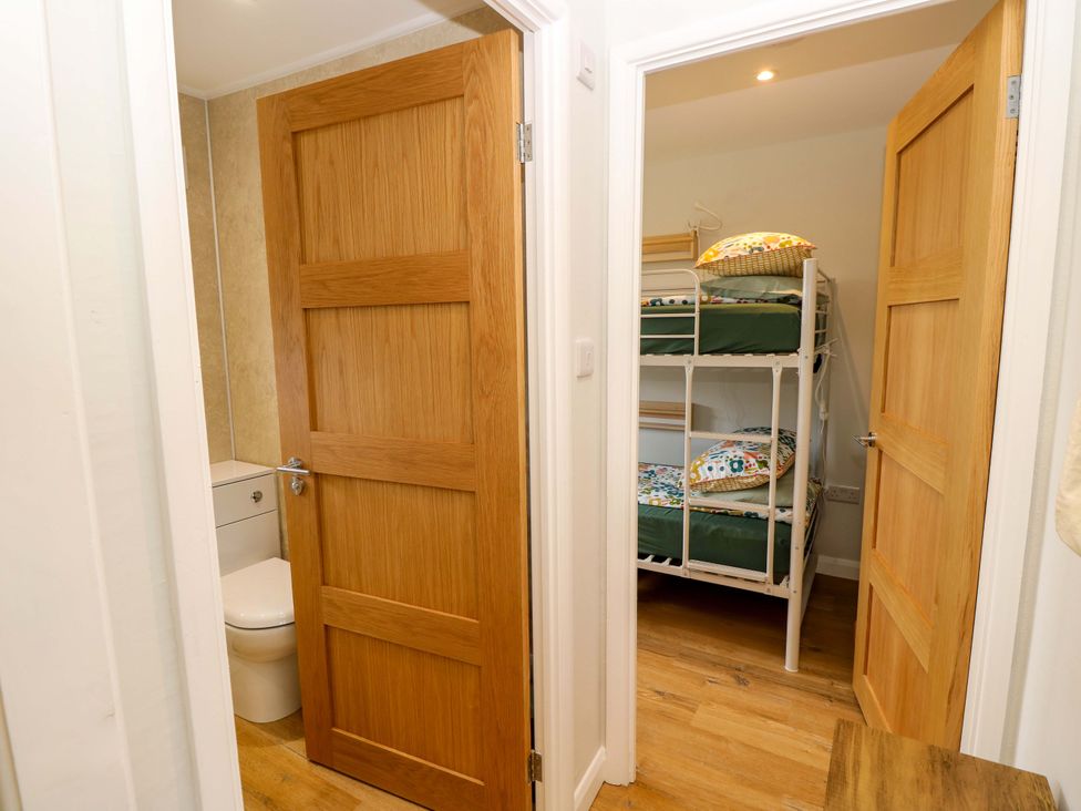 A bathroom with a toilet and a bunk bed at No 157 Sandown Bay Holiday Chalet 'Field View' Sandown
