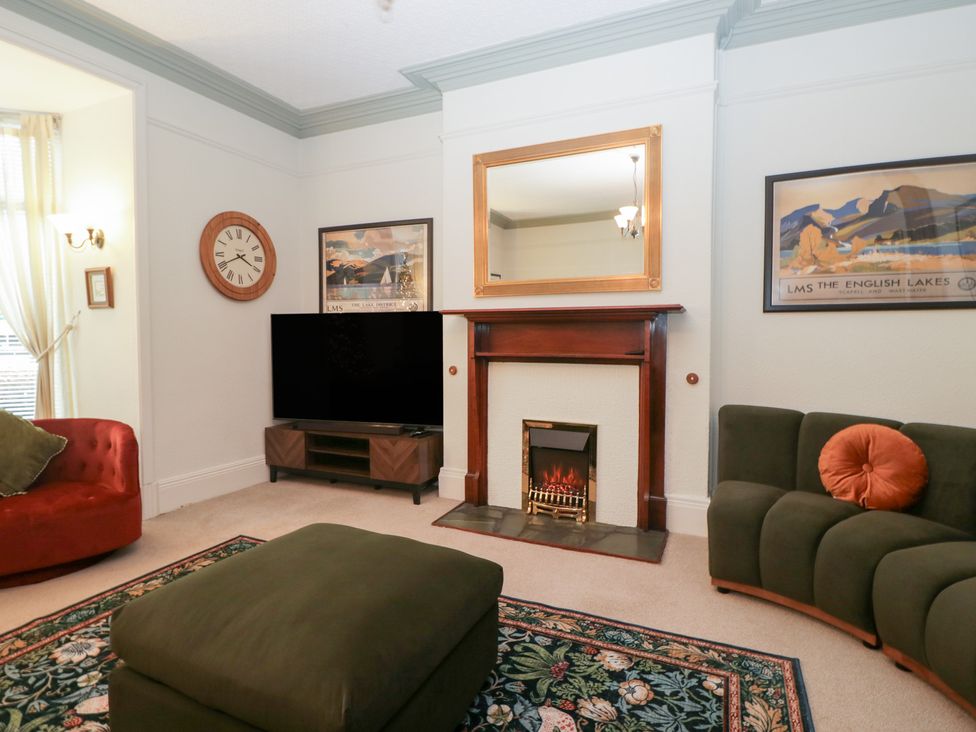 A living room with a television and fireplace at Norwood House in Ambleside